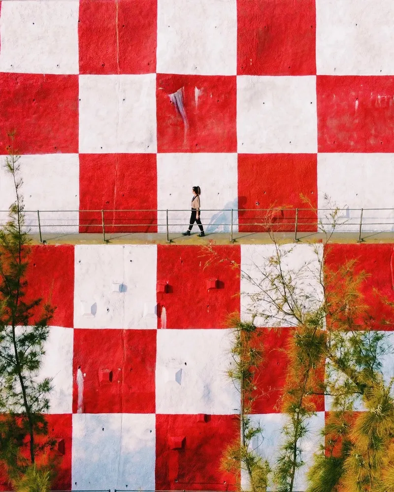 Bonnie walking in front of a checkered background