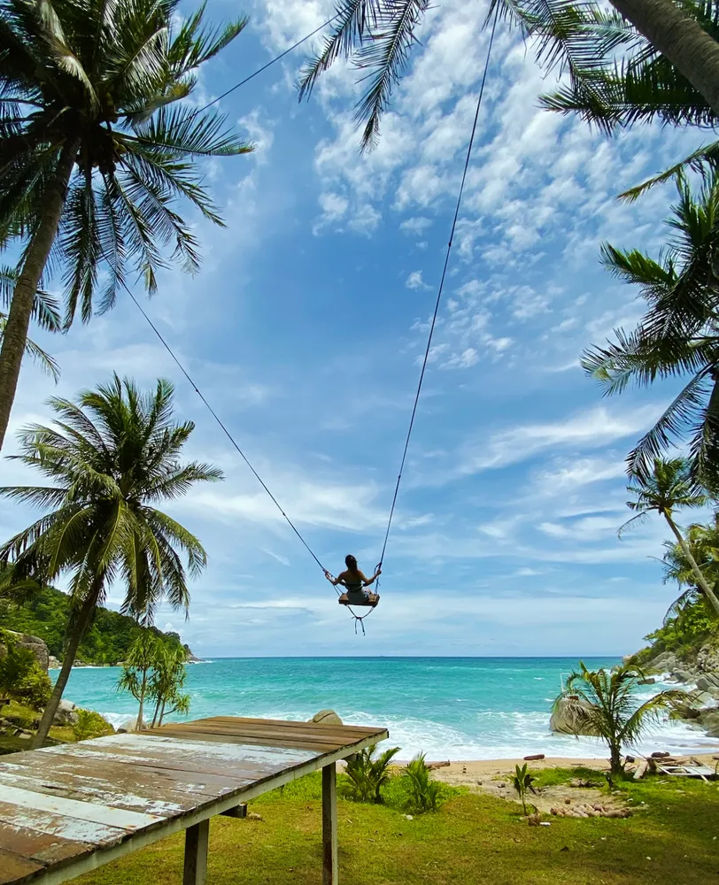 Bonnie Zeng on beachside swingset